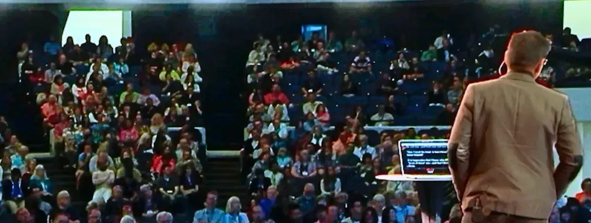 John Franklin Wiley on stage facing a packed arena